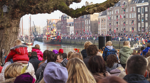 Ship of Sinterklaas entering the old harbour of historical Dordrecht while the children wait in excited anticipation	