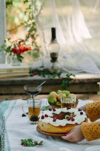 Bundt cake with saffron and rum covered with white glaze on rustic background with autumn decorations