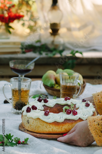 Bundt cake with cinnamon covered with white glaze on rustic background with autumn decorations photo