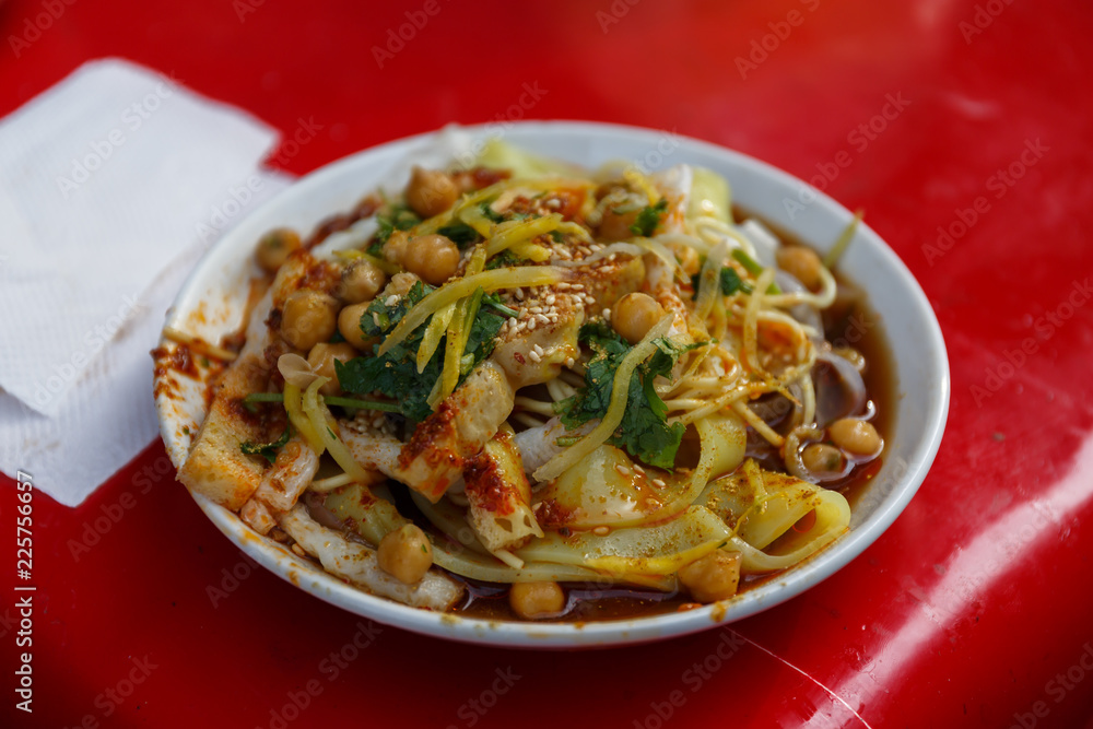 KASHGAR, XINJIANG / CHINA - October 1, 2017: Close up of Laghman Noodles - a popluar dish in Uzbekistan, Xinjiang, Kazakhstan & Kyrgyzstan. Further ingredients are meat (e. g. mutton) and vegetables. KASHGAR, XINJIANG / CHINA - October 1, 2017: Close up of Laghman Noodles - a popluar dish in Uzbekistan, Xinjiang, Kazakhstan & Kyrgyzstan. Further ingredients are meat (e. g. mutton) and vegetables.