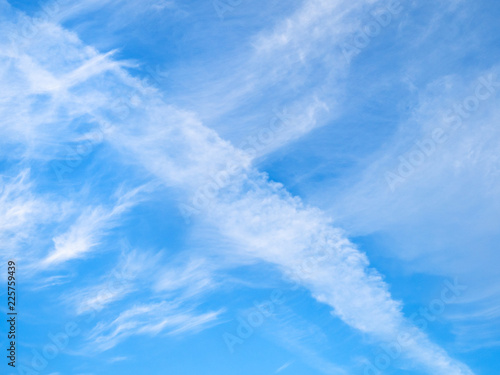 white spindrift clouds in blue sky in autumn day