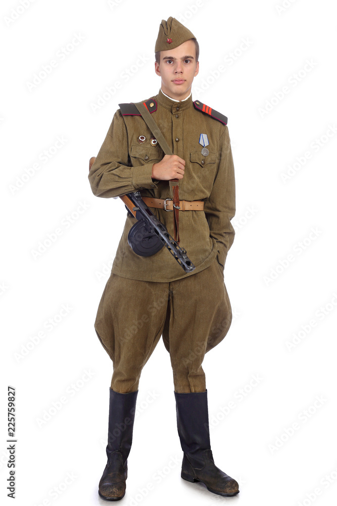 A soldier in military uniform of soviet army stay and hold submachine gun  with one hand in pocket Stock Photo | Adobe Stock