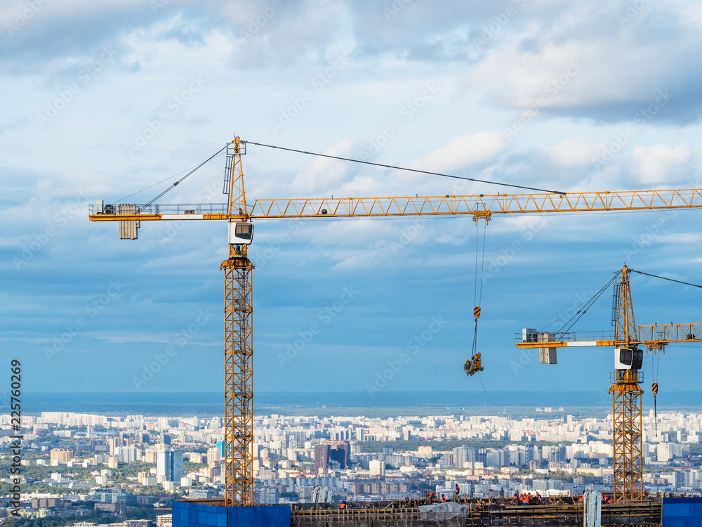 cranes on construction site of high-rise building