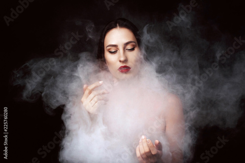 Attractive young girl and white smoke.