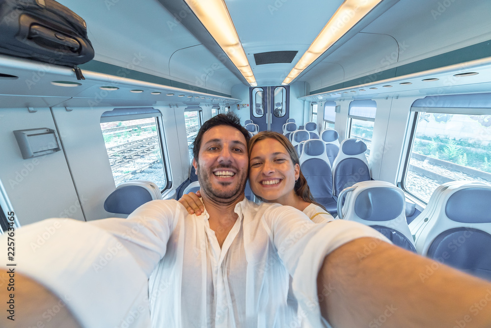 happy couple travelling take selfie on the train happy couple travelling take selfie on the train