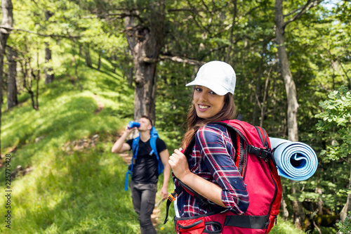 Portrait of happy female hiker at forest