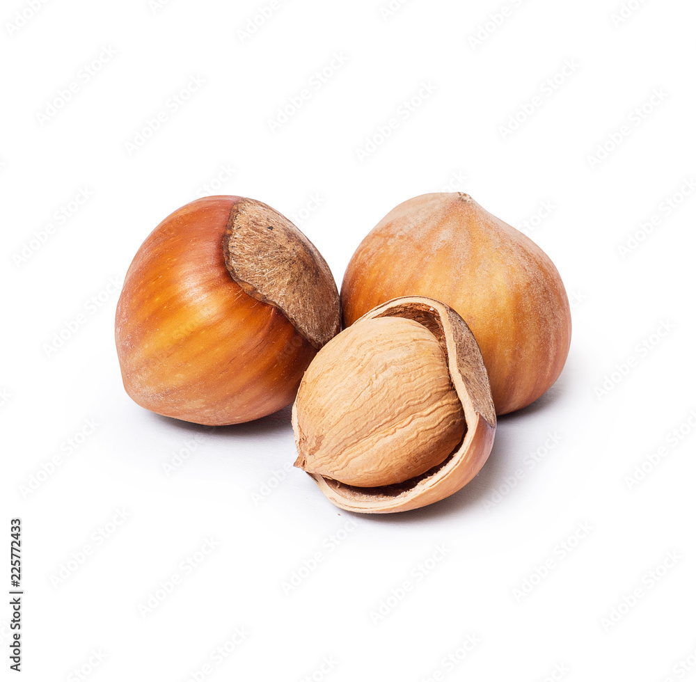Whole and broken hazelnuts closeup on white background Whole and broken hazelnuts closeup on white background