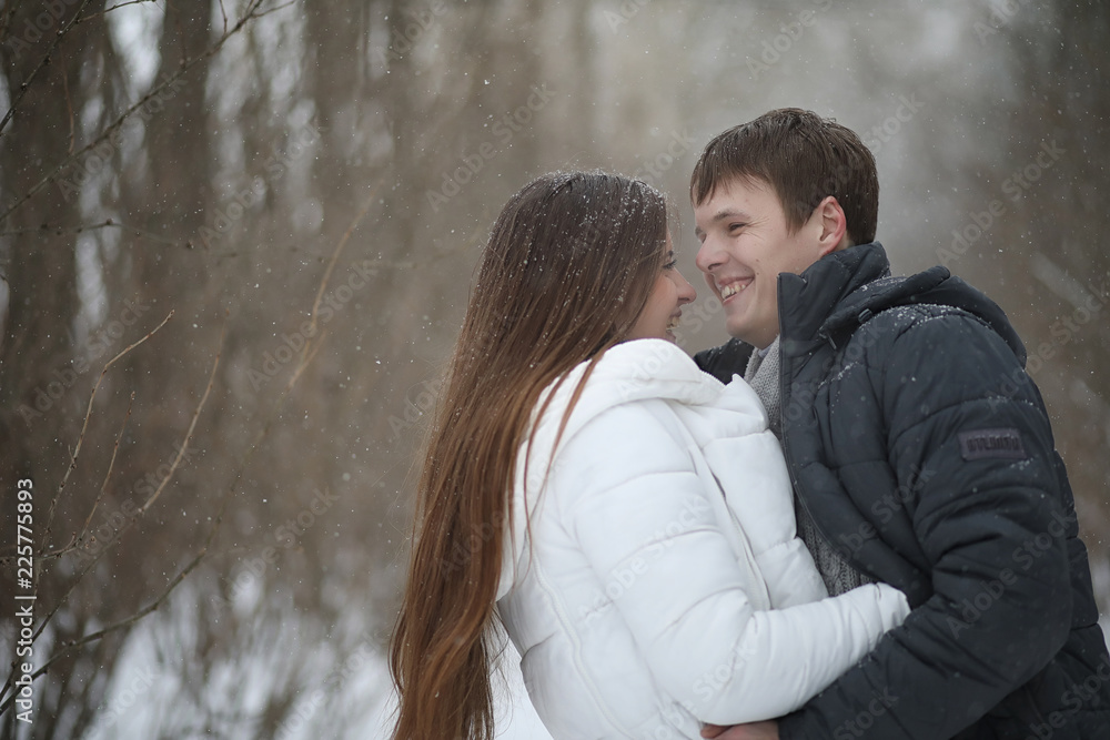 pair of lovers on a date winter afternoon in a snow blizzard pair of lovers on a date winter afternoon in a snow blizzard