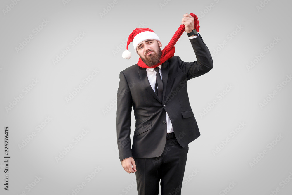 Thoughts of suicide. Unhappy businessman bankrot and dont have time to until christmas. looking at camera and holding his scarf with sad emotion, indoor studio shot isolated on gray background Thoughts of suicide. Unhappy businessman bankrot and dont have time to until christmas. looking at camera and holding his scarf with sad emotion, indoor studio shot isolated on gray background