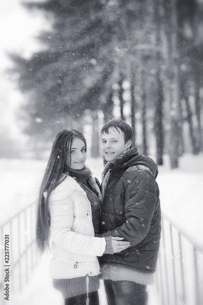 Fototapeta premium A loving couple on a winter walk. Man and woman on a date in the