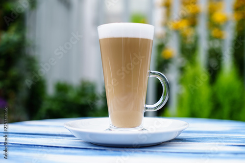 Coffee Latte top on the table at Garden with white fances photo