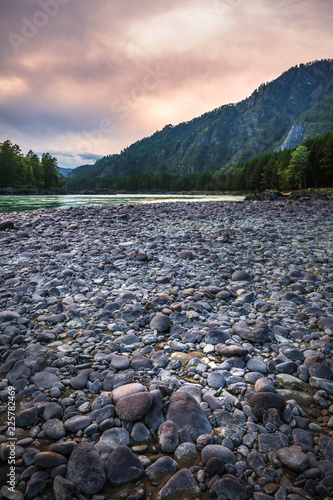 Rounded stones on the coast of the Katun river. Mountain Altai, Southern Siberia, Russia