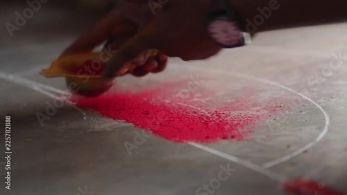 Rangoli with coloured powder being created by Rangoli artist on occasion of Hindu festival, Mumbai, Maharashtra, India.