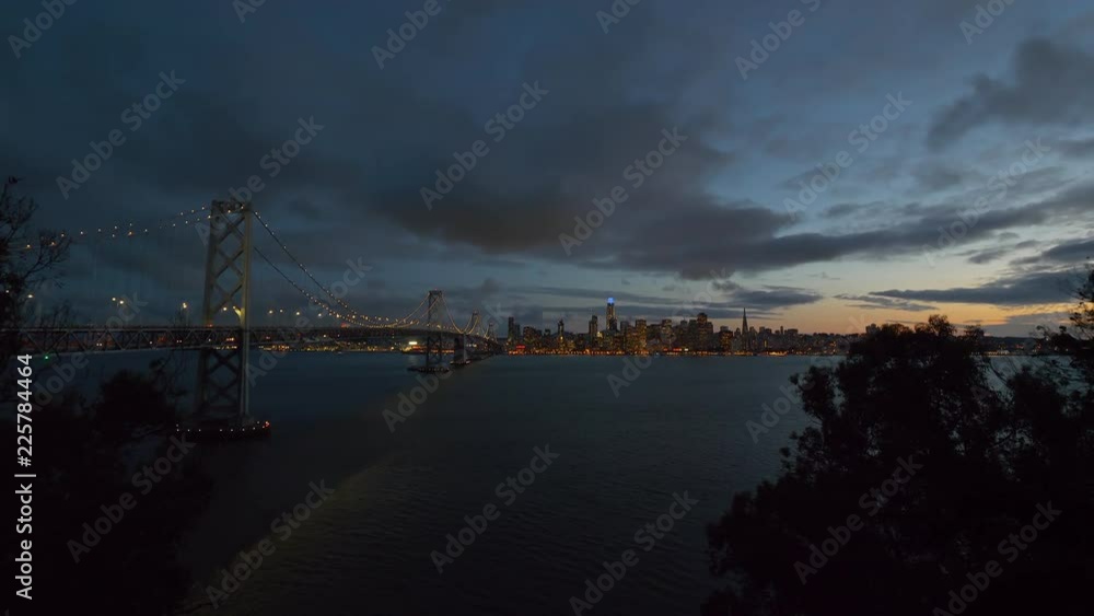 San Francisco Bay Bridge And Evening Skyline on a cloudy day. San Francisco Bay Bridge And Evening Skyline on a cloudy day.