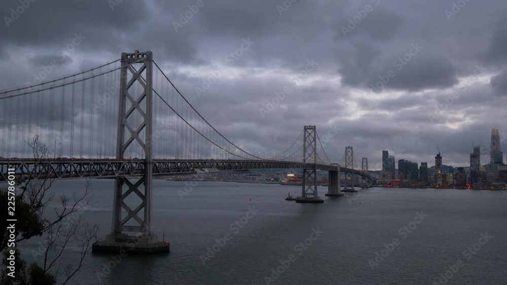 San Francisco Bay Bridge And Evening Skyline on a cloudy day. San Francisco Bay Bridge And Evening Skyline on a cloudy day.