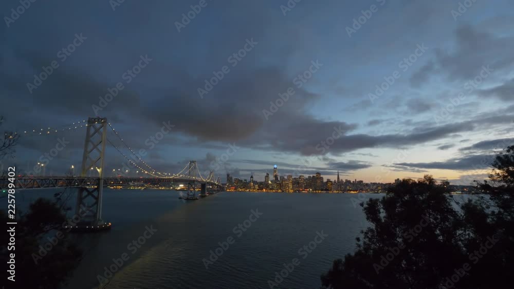 San Francisco Bay Bridge And Evening Skyline on a cloudy day. San Francisco Bay Bridge And Evening Skyline on a cloudy day.