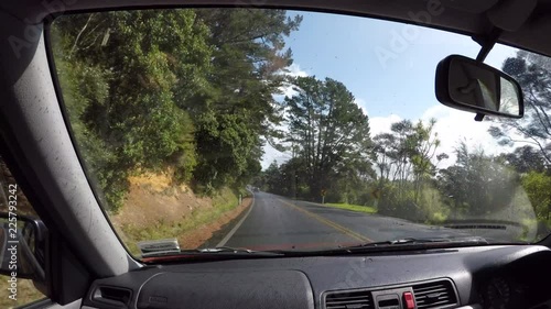 Car passenger point of view looking at rural road during a road trip in the North Island of New Zealand photo