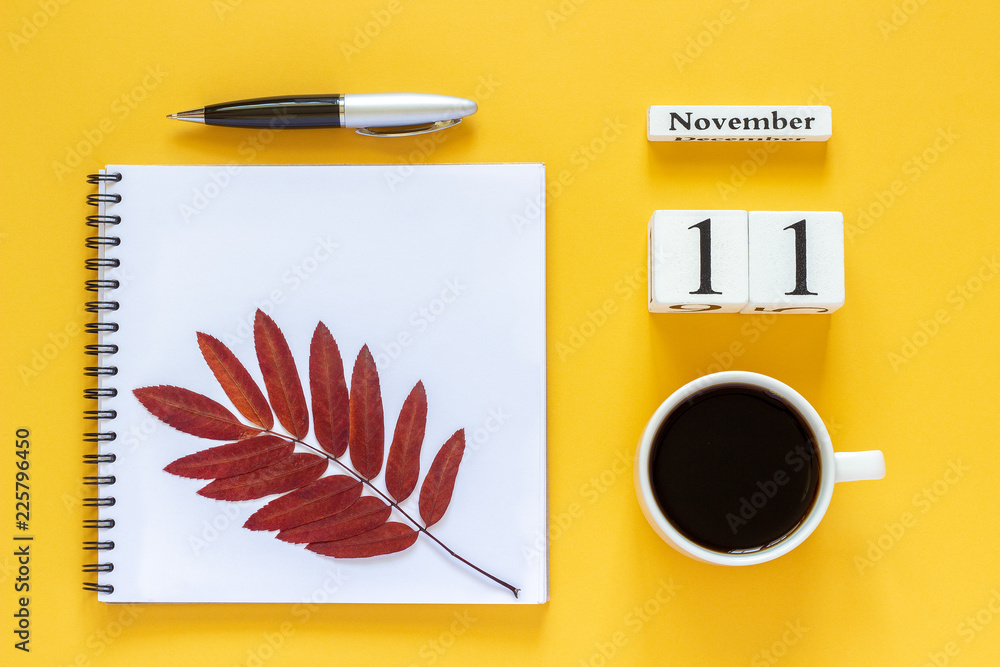 Autumn composition. Wooden calendar November 11 cup of coffee, empty open notepad with pen and yellow oak leaf on yellow background. Top view Flat lay Mockup Concept Hello November Autumn composition. Wooden calendar November 11 cup of coffee, empty open notepad with pen and yellow oak leaf on yellow background. Top view Flat lay Mockup Concept Hello November
