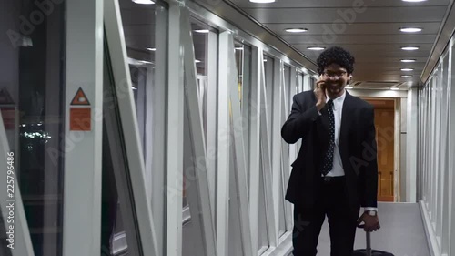 Wallpaper Mural Office going young man using mobile phone, tablet while travelling. Torontodigital.ca