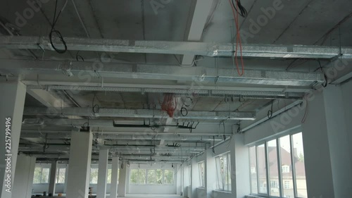 The office is in repair white walls light burning building materials builder building construction contractor engineer industrial male renovation technician development design project slow motion