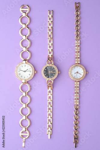 set of women's golden wrist watches with diamonds isolated