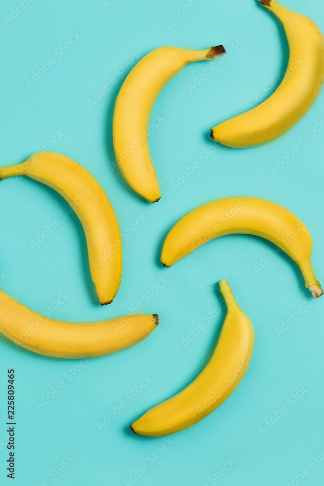 Beautiful yellow bananas on blue background. Closeup food photo Beautiful yellow bananas on blue background. Closeup food photo