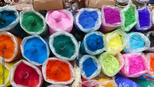footage of Bowls of earthen oil lamps, vibrant coloured dyes and Rangoli mixed with colours for sale on road side shops in Mumbai, India for Diwali Festival.