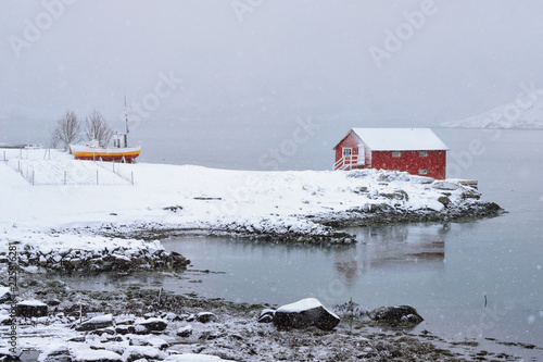 Red rorbu house in winter, Lofoten islands, Norway