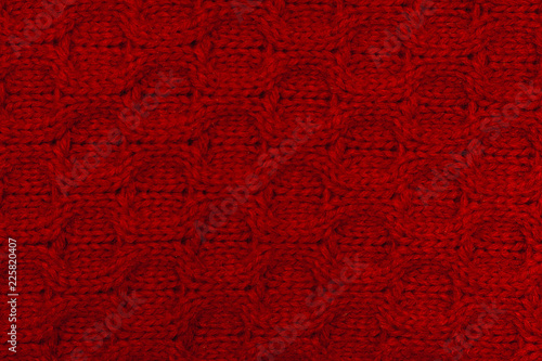 Knitted background. Knitted red texture. A knitting pattern of wool. Knitting. Background.
