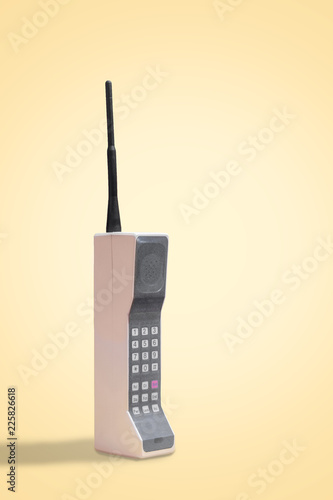 Vintage mobile, cell phone on a retro yellow background with space for copy and text