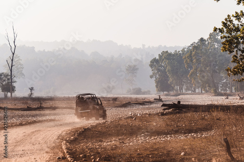 Open-top car on the field road. Competition off road and rough terrain. The Safari vehicles on the background of autumn road and the steppe. field road.