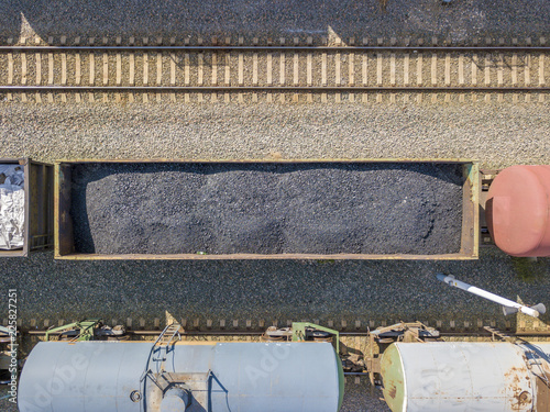 top aerial view of coal carriage cargo train on a railroad station. transportation company f