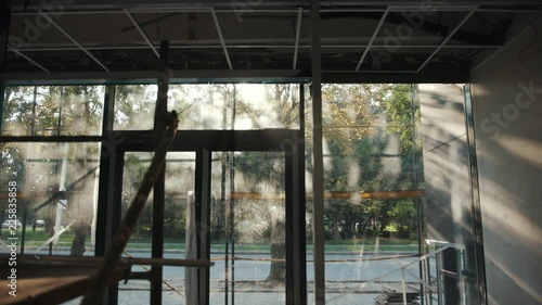 Sunlight office is in repair white walls light burning building materials builder building construction contractor engineer industrial male renovation technician development design project slow motion