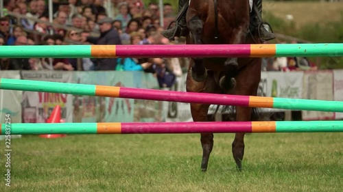 rider with horse, jumping a hurdle. Equestrian Sports. Slow motion
 photo