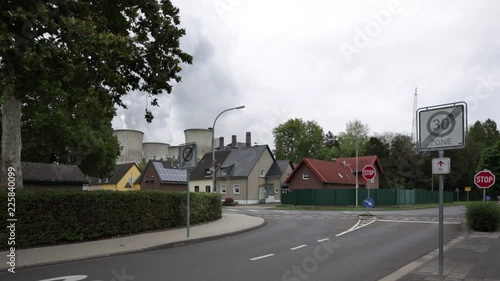 Häuser in Dorf mit Kraftwerk im Hintergrund