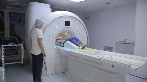A doctor conducts a patient study using an x-ray device. Progress in medicine