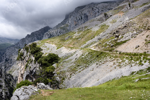 Spain, Picos de Europa, near Poncebos: Panorama view of famous Spanish Routa Trail with narrow pathway and cloudy grey sky. The path runs in between Cantabrian Mountains along Cares river's canyon. photo