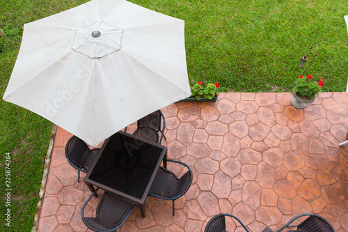 Set of chair and table with outdoor patio umbrella. Outdoor furniture. photo