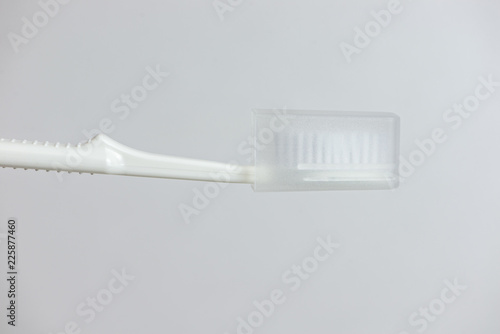 Close up white toothbrush with cover photo