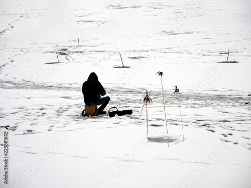 Men are engaged in winter fishing.
