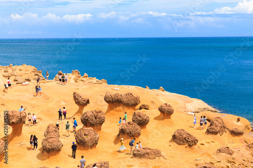 YEHLIU,TAIWAN-AUGUST 22,2017: Many tourists watch the stone Strange shape at Yehliu Geopark,These rock caused by the erosion of sea waves photo