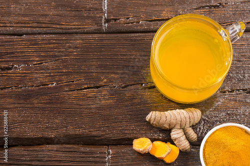 Infused turmeric drink healthy - Wooden background