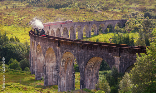 Glenfinnan railway viaduct in Scotland with the Jacobite steam train, located at the northern end of Loch Shiel of great scenic beauty