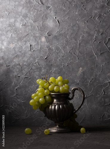 Vintage still life of grapes in a vase photo