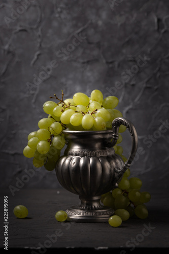 Vintage still life of grapes in a vase photo