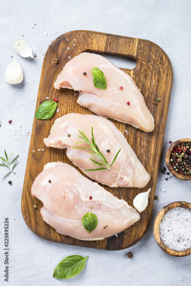Raw chicken fillet with spices and herbs top view. Raw chicken fillet with spices and herbs top view.