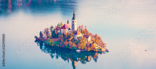 Magical autumn landscape with the island on Lake Bled (Blejsko jezero). Julian Alps, Slovenia. Attractions. Tourist places of pilgrimage. (Meditation, travel, inner peace, harmony - concept) photo