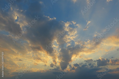 Beautiful yellow golden sunset background in blue sky 