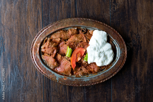 iskender Doner / Turkish Traditional Food with Yogurt in Antique Copper Plate. photo