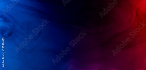 merging of colorful smoke on dark background